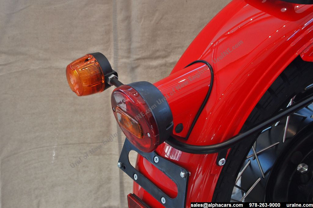 This photo shows the Retro Rear Motorcycle Light Adapter, as part of the complete Retro Rear Light Kit (including gasket and light assembly).